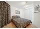 Cozy bedroom featuring carpeted floors, a paisley comforter, and a double door closet at 1332 Meadow Trl, Franktown, CO 80116