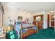 Cozy bedroom features a decorative wooden bed frame, colorful bedding, and a matching wooden dresser and nightstands at 1332 Meadow Trl, Franktown, CO 80116