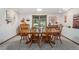 Dining room featuring wood table with seating for six, a bay window and white walls at 1332 Meadow Trl, Franktown, CO 80116