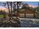 Attached two car garage with a paved driveway and mature trees at 1332 Meadow Trl, Franktown, CO 80116