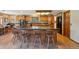 Spacious kitchen featuring a large island with seating, wooden cabinets, and modern black appliances at 1332 Meadow Trl, Franktown, CO 80116