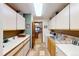 Laundry room featuring extra storage space, countertops and tile backsplash at 1332 Meadow Trl, Franktown, CO 80116