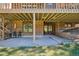 Spacious brick patio with seating area under a covered deck provides a great outdoor space at 1332 Meadow Trl, Franktown, CO 80116