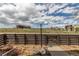 Backyard features a view of the neighborhood and construction site behind a wooden fence at 8953 Southurst St, Littleton, CO 80129
