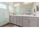 Bathroom with double vanity, walk-in shower, and tile accents at 8953 Southurst St, Littleton, CO 80129