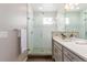 Modern bathroom showcasing a glass-enclosed shower and sleek vanity with neutral color palette at 8953 Southurst St, Littleton, CO 80129