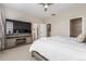 Spacious bedroom featuring a large TV, electric fireplace and access to ensuite bathroom and walk-in closet at 8953 Southurst St, Littleton, CO 80129