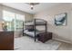 Cozy bedroom featuring a bunk bed, ceiling fan, and window with blinds at 8953 Southurst St, Littleton, CO 80129