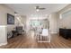 Dining area with hardwood floors, neutral paint, modern lighting and decor, and easy access to kitchen and living area at 8953 Southurst St, Littleton, CO 80129
