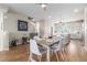 Open-concept dining area with a wooden table, seating for six, and a view into the kitchen at 8953 Southurst St, Littleton, CO 80129