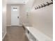 Bright entryway features modern finishes, tiled floors, and a built-in bench for added convenience at 8953 Southurst St, Littleton, CO 80129