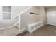 Bright entryway with a built-in bench, coat hooks, and stairs leading to the upper level at 8953 Southurst St, Littleton, CO 80129