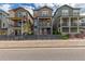 Street view of two-story homes with individual front yards with horizontal wood fencing at 8953 Southurst St, Littleton, CO 80129