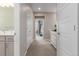 Hallway featuring carpeted flooring, neutral paint, and entryways to rooms and bathrooms at 8953 Southurst St, Littleton, CO 80129