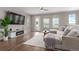 Comfortable living room featuring a large sectional sofa, modern entertainment center, and scenic backyard views at 8953 Southurst St, Littleton, CO 80129