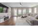 Bright living room features a sectional sofa, modern entertainment center, and scenic outdoor views at 8953 Southurst St, Littleton, CO 80129