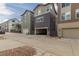 View of modern townhomes, each with a private garage, on a well-maintained street at 8953 Southurst St, Littleton, CO 80129