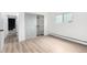 Bright bedroom featuring wood-look floors, a closet, and a window for natural light at 3470 S Poplar St # 401, Denver, CO 80224