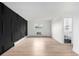 Empty bedroom featuring unique black accent wall, window, and renovated bathroom at 3470 S Poplar St # 401, Denver, CO 80224