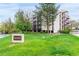 Well-maintained condo building with lush green lawn and mature trees in a desirable community at 3470 S Poplar St # 401, Denver, CO 80224