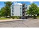 Charming apartment building with mature trees and an inviting exterior, a prime example of urban living at 3470 S Poplar St # 401, Denver, CO 80224