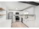 Bright kitchen with modern cabinets, stainless steel appliances, and stylish herringbone backsplash at 3470 S Poplar St # 401, Denver, CO 80224