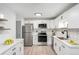 Bright kitchen with modern cabinets, stainless steel appliances, and stylish herringbone backsplash at 3470 S Poplar St # 401, Denver, CO 80224