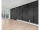 Inviting living room with modern black accent wall and light wood flooring at 3470 S Poplar St # 401, Denver, CO 80224