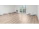 Spacious living room with wood-look flooring and a sliding glass door leading to a private balcony at 3470 S Poplar St # 401, Denver, CO 80224