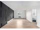 Open living space with black accent wall and a bathroom entrance at 3470 S Poplar St # 401, Denver, CO 80224