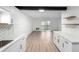 Open-concept living space with modern finishes and a sliding glass door to a private balcony at 3470 S Poplar St # 401, Denver, CO 80224