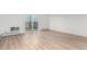 Bright living room featuring wood floors, a sliding glass door, and neutral walls at 3470 S Poplar St # 401, Denver, CO 80224