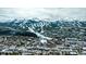 Majestic aerial view featuring snow-capped mountains and a charming town nestled at the base of a mountain and ski area at 62 Broken Lance Dr # 202E, Breckenridge, CO 80424