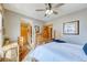 Comfortable bedroom with rustic wood accents, a ceiling fan, and a well-lit interior at 62 Broken Lance Dr # 202E, Breckenridge, CO 80424
