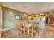 Open-concept dining area with wood floors, stylish decor, and seamless flow to the kitchen at 62 Broken Lance Dr # 202E, Breckenridge, CO 80424