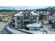 Lovely three-story home with attractive architectural details, balconies and snow covered roof at 62 Broken Lance Dr # 202E, Breckenridge, CO 80424
