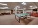 Spacious game room featuring a ping pong table, foosball table, leather sofa, and neutral-colored walls at 62 Broken Lance Dr # 202E, Breckenridge, CO 80424