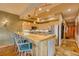 Spacious kitchen with stainless steel appliances, ample counter space, and a breakfast bar overlooking the living area at 62 Broken Lance Dr # 202E, Breckenridge, CO 80424