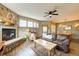 Cozy living room with a stone fireplace and leather furnishings, complemented by wood floors and natural light at 62 Broken Lance Dr # 202E, Breckenridge, CO 80424