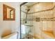 Elegant walk-in shower with glass doors, tiled walls, and built-in bench at 62 Broken Lance Dr # 202E, Breckenridge, CO 80424