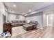Inviting basement boasts a comfortable leather sectional and wood-look flooring, perfect for relaxation and entertainment at 6365 Orion Ct # B, Arvada, CO 80403
