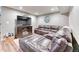Finished basement offers a plush leather sectional, a television, and stylish wood-look flooring, perfect for relaxation at 6365 Orion Ct # B, Arvada, CO 80403