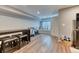 Well-lit basement area with stool seating, an exercise bike, and a window seat, perfect for recreation and relaxation at 6365 Orion Ct # B, Arvada, CO 80403