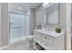 Clean, well-lit bathroom featuring a glass-enclosed shower and a modern vanity, blending functionality and style at 6365 Orion Ct # B, Arvada, CO 80403