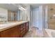 Bathroom boasts double sinks, modern fixtures, and a separate glass-enclosed shower, promoting a spa-like experience at 6365 Orion Ct # B, Arvada, CO 80403