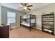 This bedroom features a bunk bed, a ceiling fan, and a window, providing a cozy and functional space for  at 6365 Orion Ct # B, Arvada, CO 80403