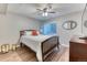 Cozy bedroom featuring a comfortable bed, a ceiling fan, and a window, creating a relaxing retreat at 6365 Orion Ct # B, Arvada, CO 80403