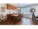 Bright dining room with built-in cabinets, hardwood floors, and a large window at 6365 Orion Ct # B, Arvada, CO 80403