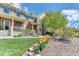 Beautiful townhome facade featuring a manicured lawn and colorful tulip garden at 6365 Orion Ct # B, Arvada, CO 80403
