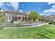 Landscaped front yard and well-maintained exterior of a brick and siding townhome at 6365 Orion Ct # B, Arvada, CO 80403